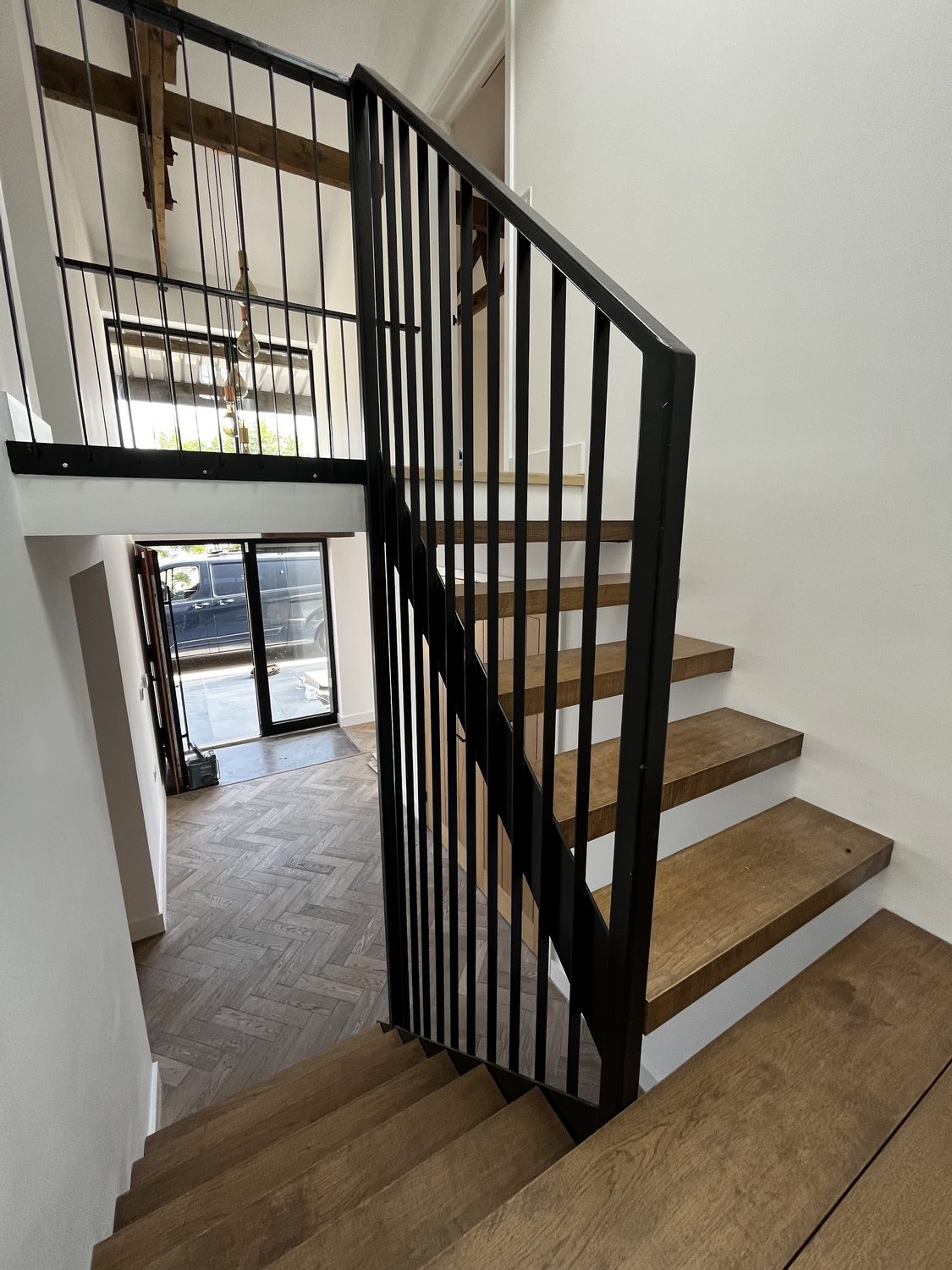Oak Staircase and Black Steel Balustrade in a Glazed Void